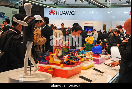 Barcelona, Spain. 25th Feb, 2013. Visitors of the Mobile World Congress look at new smartphones at the stand of Huawei in Barcelona, Spain, 25 February 2013. The Chinese manufacturer is trying to secure a place in the hotly contested smartphone market. The Mobile World Congress is open until Thursday exibiting new products and solutions in the industry. Photo: Peter Zschunke/dpa/Alamy Live News Stock Photo