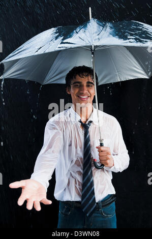 Businessman enjoying in the rain Stock Photo