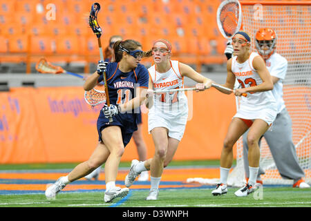 Feb. 24, 2013 - Syracuse, New York, U.S - February 24, 2013: Virginia Cavaliers attacker Ashlee Warner #11 drives to the goal around Syracuse Orange defender Maddy Huegel #77 during the second half of an NCAA Women's Lacrosse game between the Virginia Cavaliers and the Syracuse Orange at the Carrier Dome in Syracuse, New York. Syracuse defeated Virginia 10-9. Stock Photo