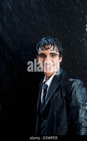 Businessman enjoying in the rain Stock Photo