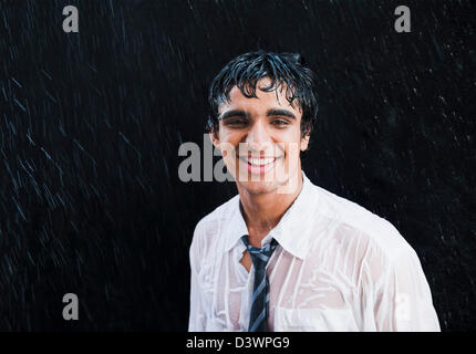 Businessman enjoying in the rain Stock Photo
