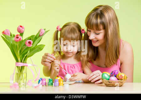 mother and daughter kid painting easter eggs Stock Photo