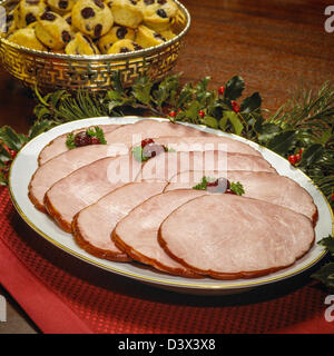 Family dinner servings, honey glazed, baked ham. Stock Photo