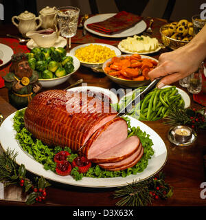 Family dinner servings, honey glazed, baked ham. Stock Photo