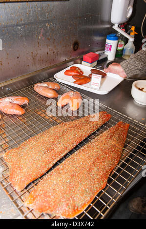 Salmon and cod roe being prepared to be smoked at a smoke house in the Uk Stock Photo