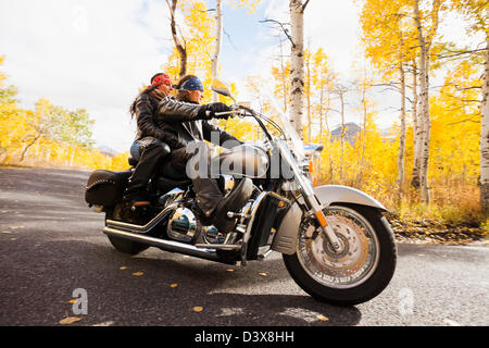 Caucasian couple riding motorcycle Stock Photo