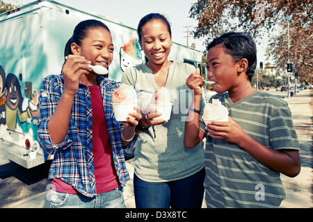 Family eating ice cream from truck Stock Photo