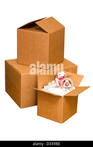 Shipping boxes with packing peanuts and tape dispenser isolated on white background with clipping path. Stock Photo