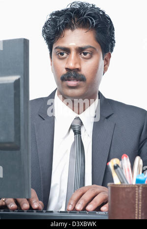 South Indian businessman working on a computer Stock Photo