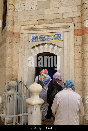 Turkish women pilgrims entering the tomb of Fatma Hatun at Mevlana Museum Konya Turkey Stock Photo