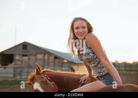 Caucasian girl sitting on horse Stock Photo