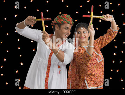 Couple performing Dandiya Raas at Navratri Stock Photo - Alamy