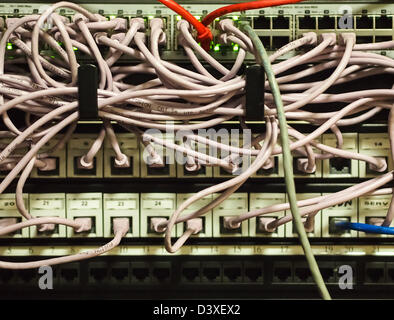 Tangled router cables plugged into a commercial server Stock Photo