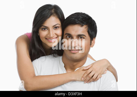Woman hugging her husband from behind Stock Photo