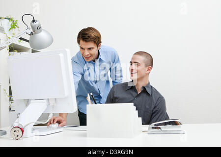 senior IT professional having fun training new office computer staff Stock Photo