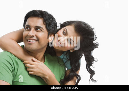 Woman hugging her husband from behind Stock Photo