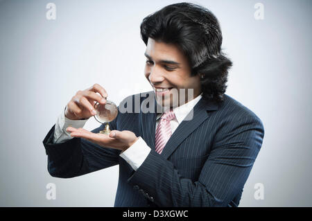 Businessman holding a small crystal globe Stock Photo