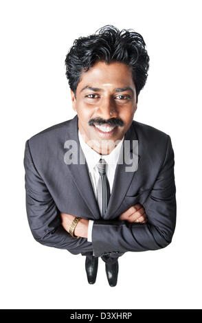 South Indian businessman standing with his arms crossed Stock Photo - Alamy