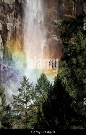 Unique Close-up view of brilliant colorful rainbow in the soft mist of lower Bridal Veil Falls Yosemite National Park. Stock Photo