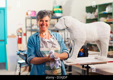 Caucasian sculptor working in studio Stock Photo