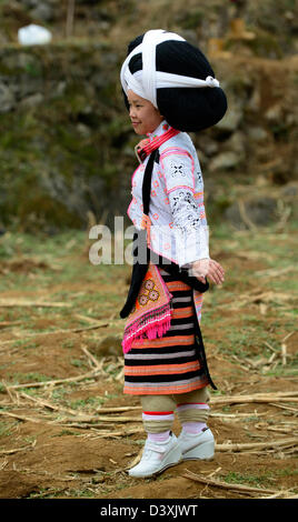 A Long Horn Miao little girl in traditional costumes dancing to celebrate the Tiao Hua festival / spring in Guizhou. Stock Photo