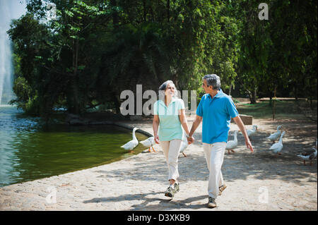 Mature couple walking in a park and smiling, Lodi Gardens, New Delhi, India Stock Photo