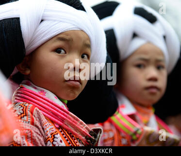 A Long Horn Miao little girl in traditional costumes dancing to celebrate the Tiao Hua festival / spring in Guizhou. Stock Photo