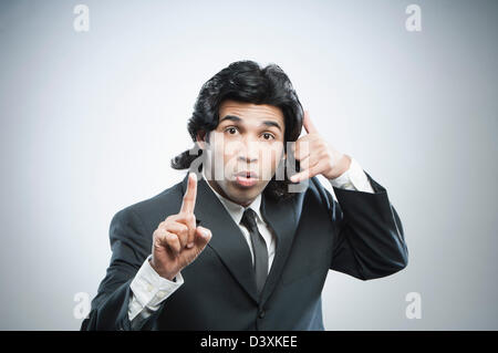 Businessman showing Call Me gesture Stock Photo