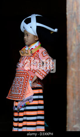 A Long Horn Miao teenage girl at her home in Long Ga village. Stock Photo