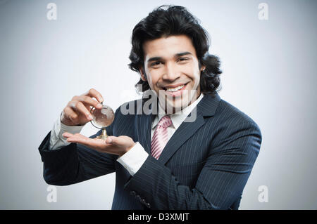 Businessman holding a small crystal globe Stock Photo
