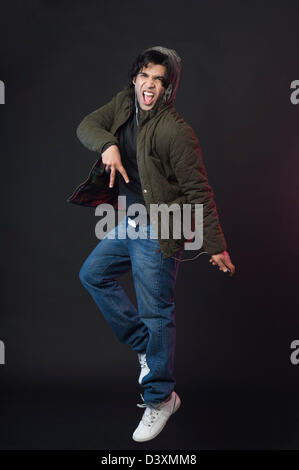 Man listening to MP3 player and dancing Stock Photo
