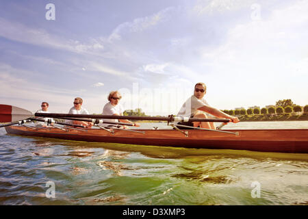 Teamwork and Coordination Concept of Friends in Men Rowing Team Stock Photo