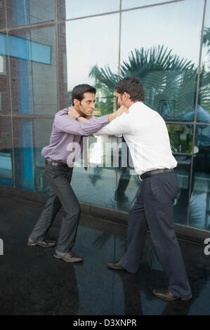 Two businessmen fighting to each other Stock Photo