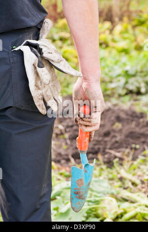 Man in his garden cultivating the land and preparing the ground for a new season Stock Photo