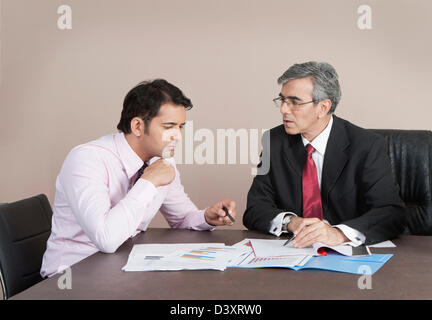 Business executives discussing a report Stock Photo