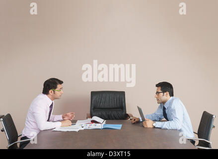 Business executives talking to each other in office Stock Photo
