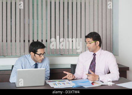 Two businessmen discussing a report Stock Photo