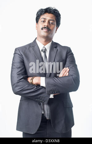 South Indian businessman standing with his arms crossed Stock Photo - Alamy