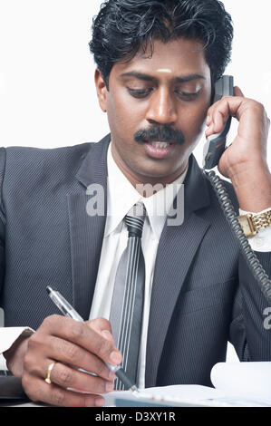 South Indian businessman talking on a phone Stock Photo