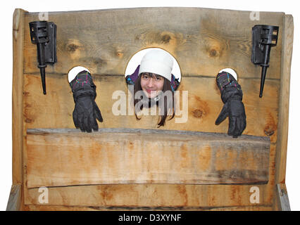 A young girl trapped in a medieval torture device Stock Photo