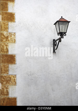 Classic street lantern with wrought iron, on the wall of the old house Stock Photo