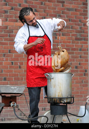 A volunteer deep fries a turkey for the needy and homeless during a holiday Thanksgiving dinner in New Haven Connecticut USA Stock Photo