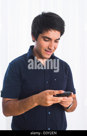 Man text messaging on a mobile phone Stock Photo