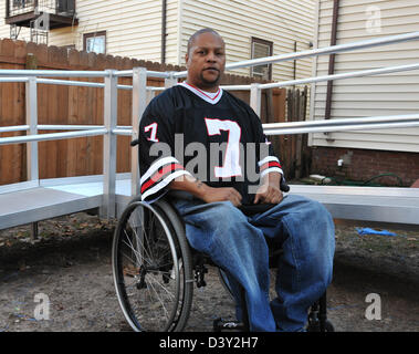 Jonathan Hicks, who is paralyzed from the waist down from a gunshot years ago, sits near the wheelchair ramp at his home. Stock Photo