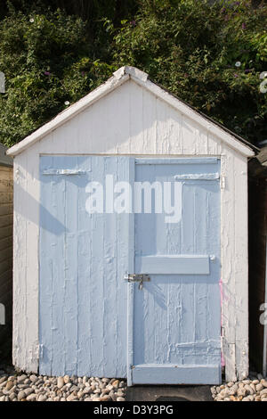 A rustic wooden beach hut painted in pastel blue and white. Stock Photo