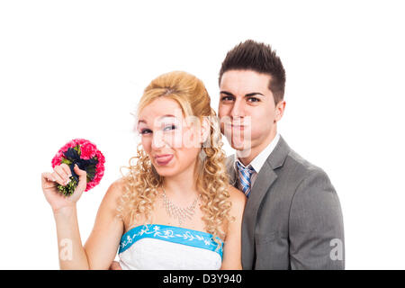 Wedding couple making funny faces, isolated on white background. Stock Photo