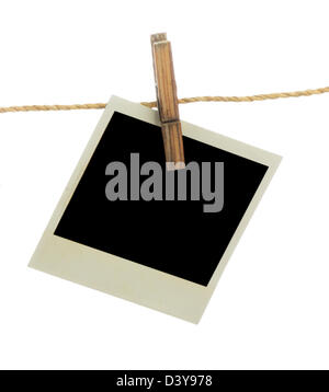 Blank instant photo hanging on the clothesline. Isolated on white background. Stock Photo