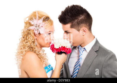 Loving wedding couple holding flower, isolated on white background. Stock Photo