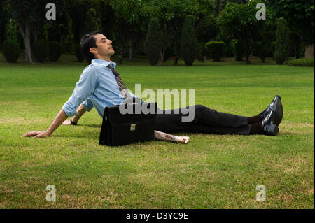 Businessman resting in a park Stock Photo