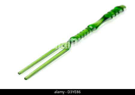 Green disposable plastic cocktail fork isolated on white Stock Photo